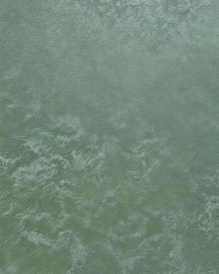 A sage green Ducsia surface, a soft metallic finish with a cloud-like movement