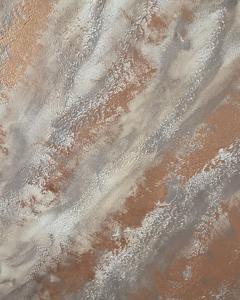 A travertino stone-effect surface with copper worked into the relief
